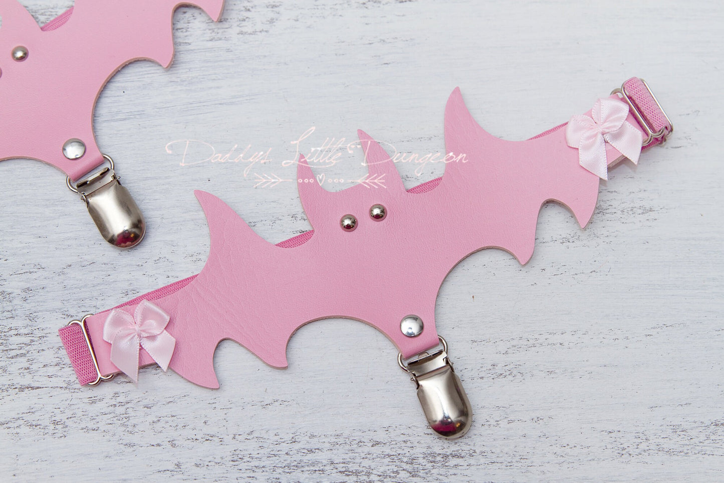 Cute pink DDLG bat and bow thigh garter set for bondage, cosplay and BDSM.